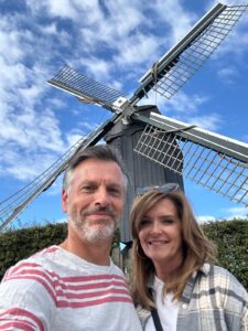 Founders Tori and Harry in front of a Dutch windmill