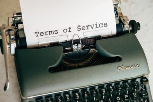 Close-up of a vintage typewriter printing 'Terms of Service' on paper